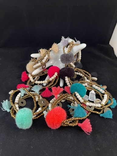 available at m. lynne designs Cream Big Pom Bracelet with Tassles and Coins