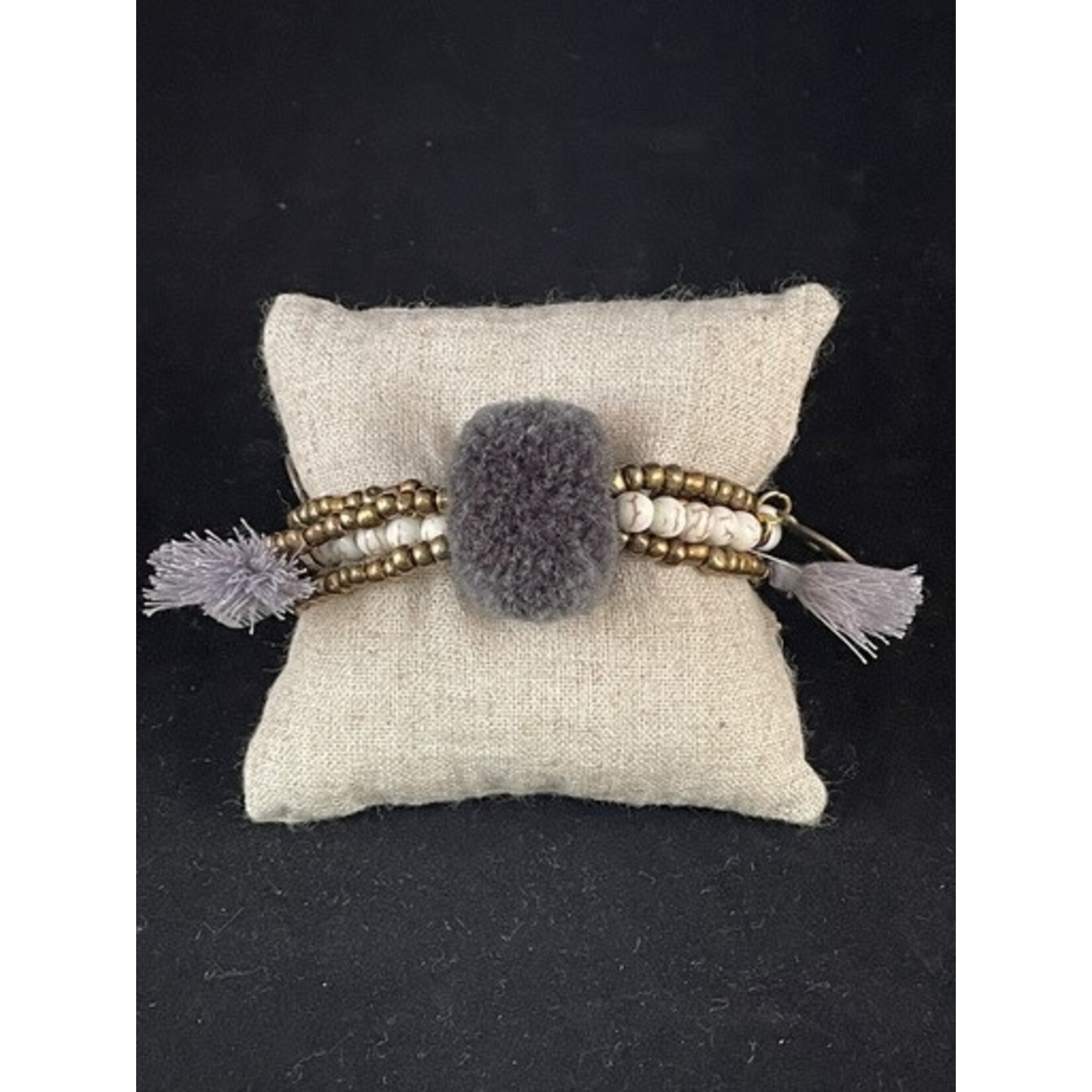 m. lynne designs gray big pom bracelet with tassels and coins