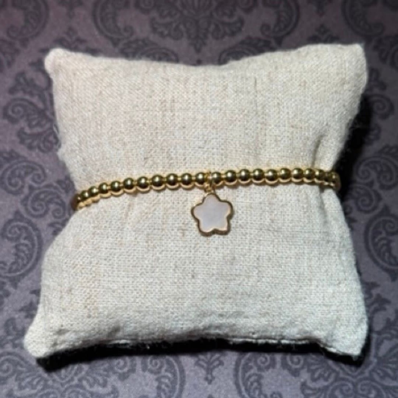 stainless gold bead bracelet with mother of pearl clover charm