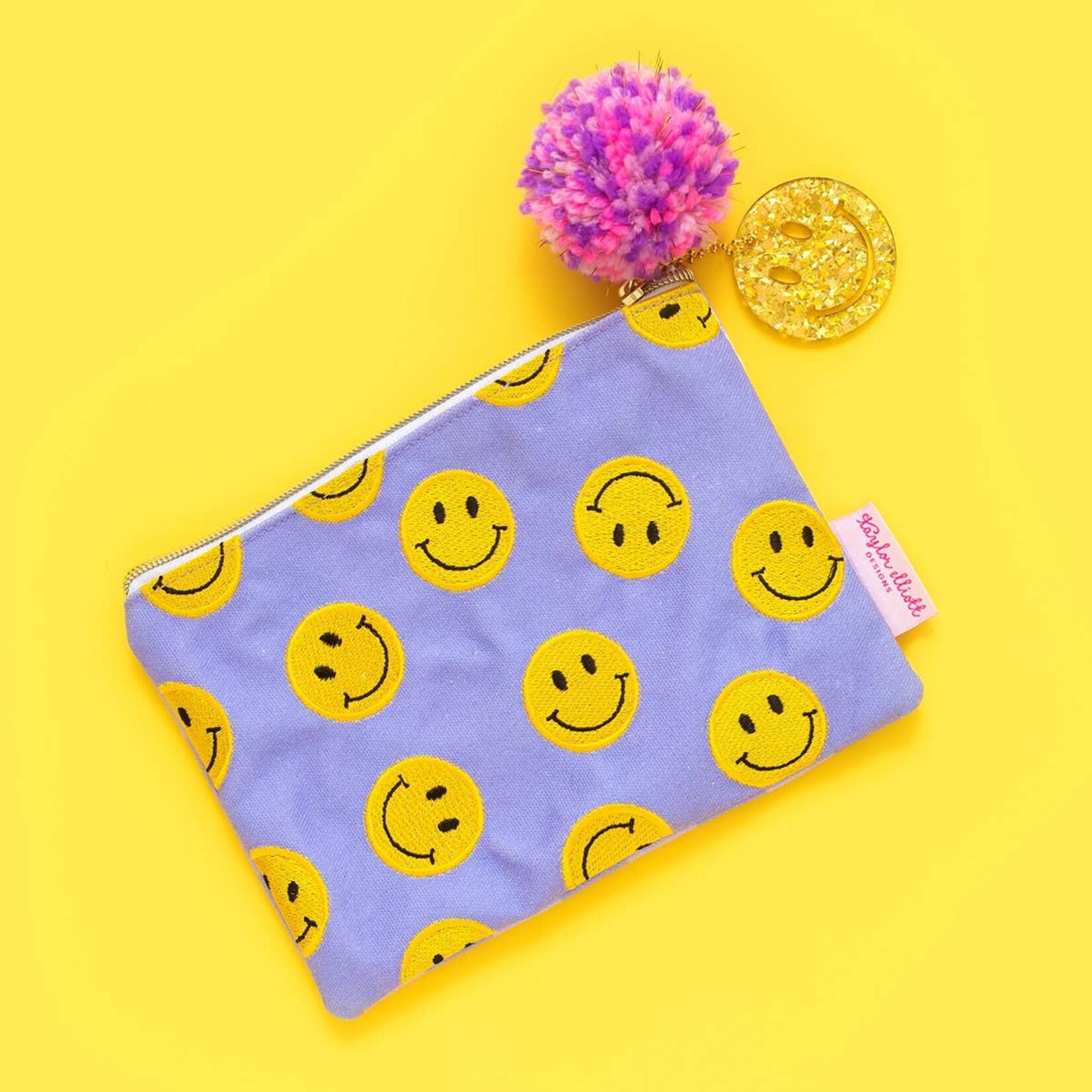 taylor elliott purple smiley pom pouch - smile bag