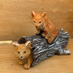Miniature Foxes on Log