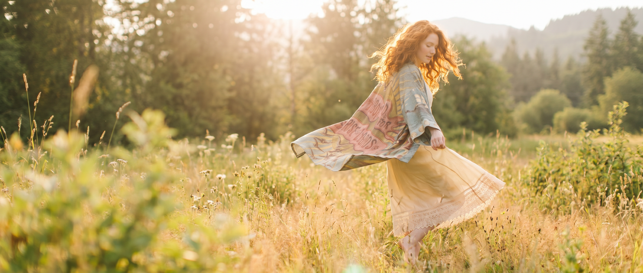 woman in a field wearing the sunrise lands matinee duster kimono from market of stars