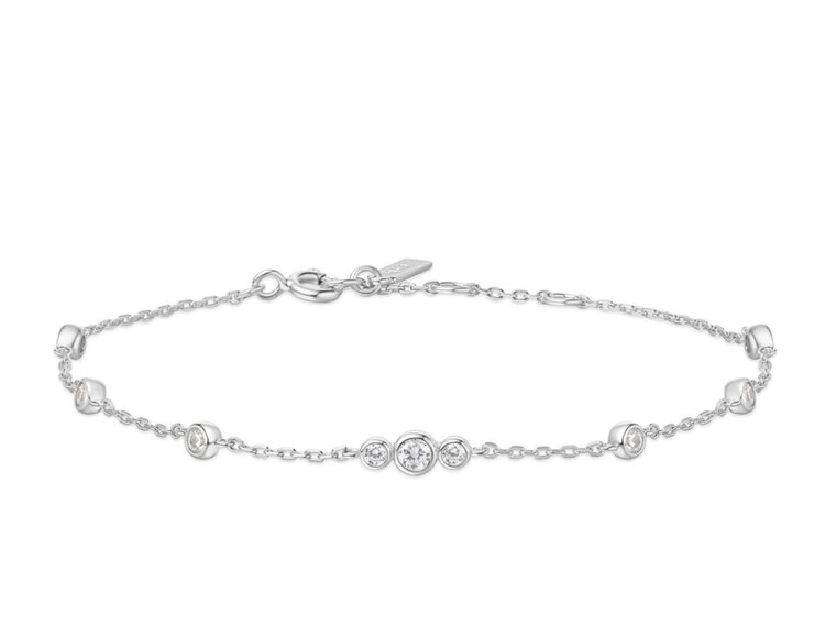 ANIA HAIE Silver Sparkling Bezel Cubic Zirconia Station Bracelet • Material: 925 Sterling Silver with Rhodium Plating with Cubic Zirconia • Bracelet length: 165mm with 20mm extender • Weight: 1.9g