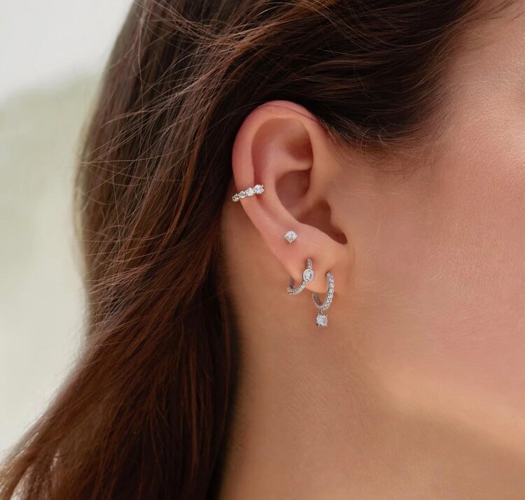 ANIA HAIE Graduated Sparkle Huggie Hoop Earrings • Material: 925 Sterling Silver with Rhodium Plating with Cubic Zirconia • Hoop Diameter: 6.5mm • Hoop Width: 1.5mm • Weight: 1.2g