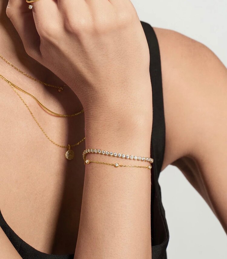 ANIA HAIE Gold Row Bezel Set Bracelet • Material: 925 Sterling Silver with 14kt Gold Plating with Cubic Zirconia • Bracelet Length: 165mm with 20mm extender • Weight: 4.0g