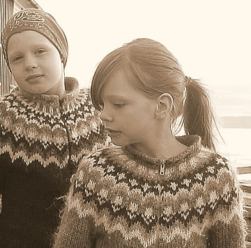 Icelandic girls wearing traditionally patterned lopapeysa sweaters. Photo by Salvor Gissurardottir  The initial design that spurred the iconic Icelandic round-yoke sweaters was inspired by the national costumes worn by women in Greenland. In the 1930s, Norwegian designer Annichen Sibbern Bøhn created a sweater called Eskimo. Around the same time, designers from other Scandinavian countries came up with their own versions of the round yoke sweater. Icelandic designers and knitters added to the trend by knitting them entirely by hand – a practice still continued to this day – and exclusively with Icelandic 