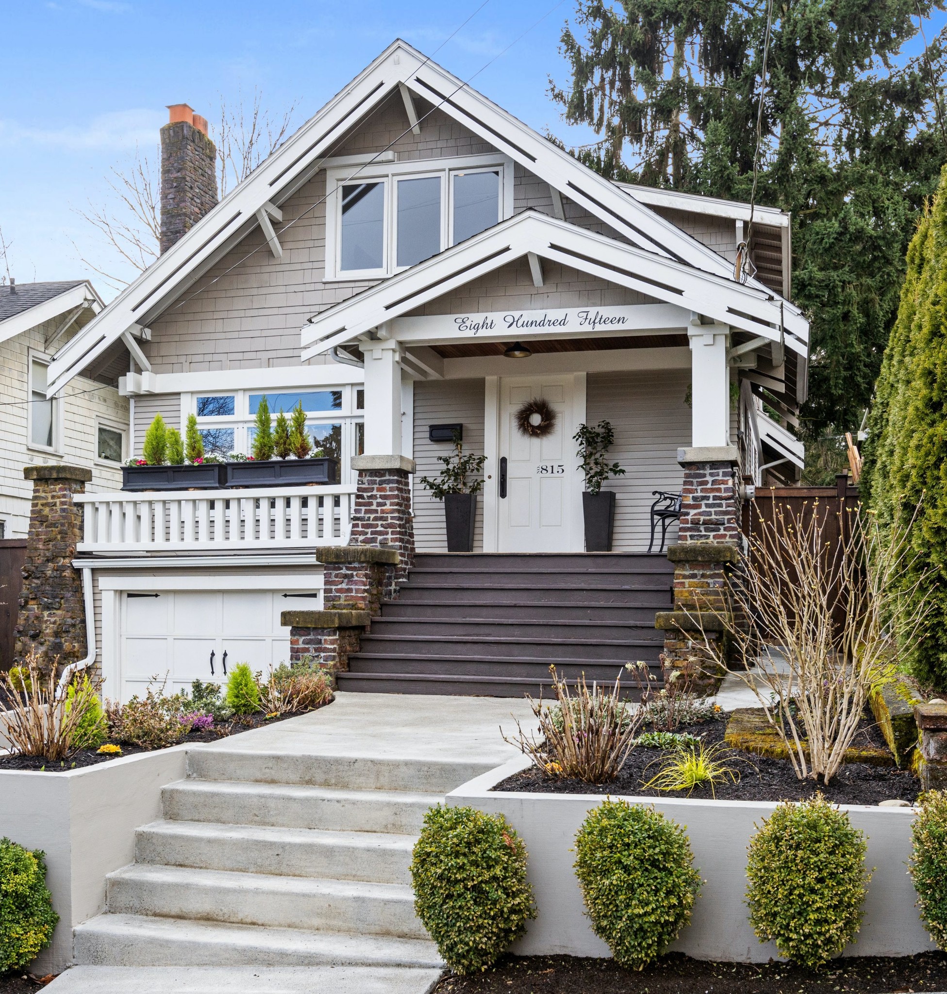 Neutral Home with exterior pots and planters.