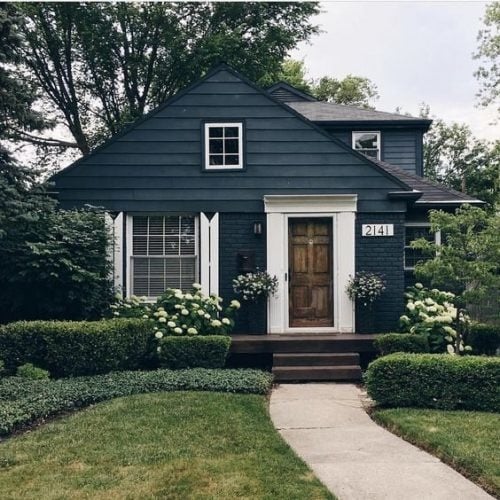 Charcoal home with black and White House numbers