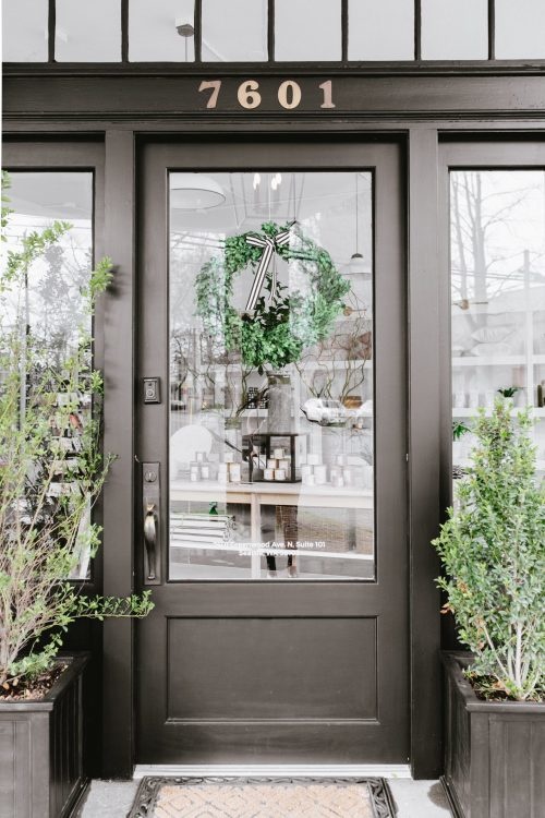 Black front door with gold house numbers at The Phinery. 