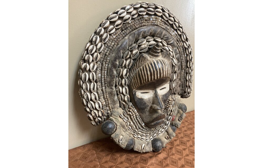 Dan (Yacuba) "Go Ge" mask: The job of this mask is to announce the death of the chief. The dan are found in SW ivory coast and next door in Liberia. Wood, cowrie shells, fabric, and kaolin (white colo