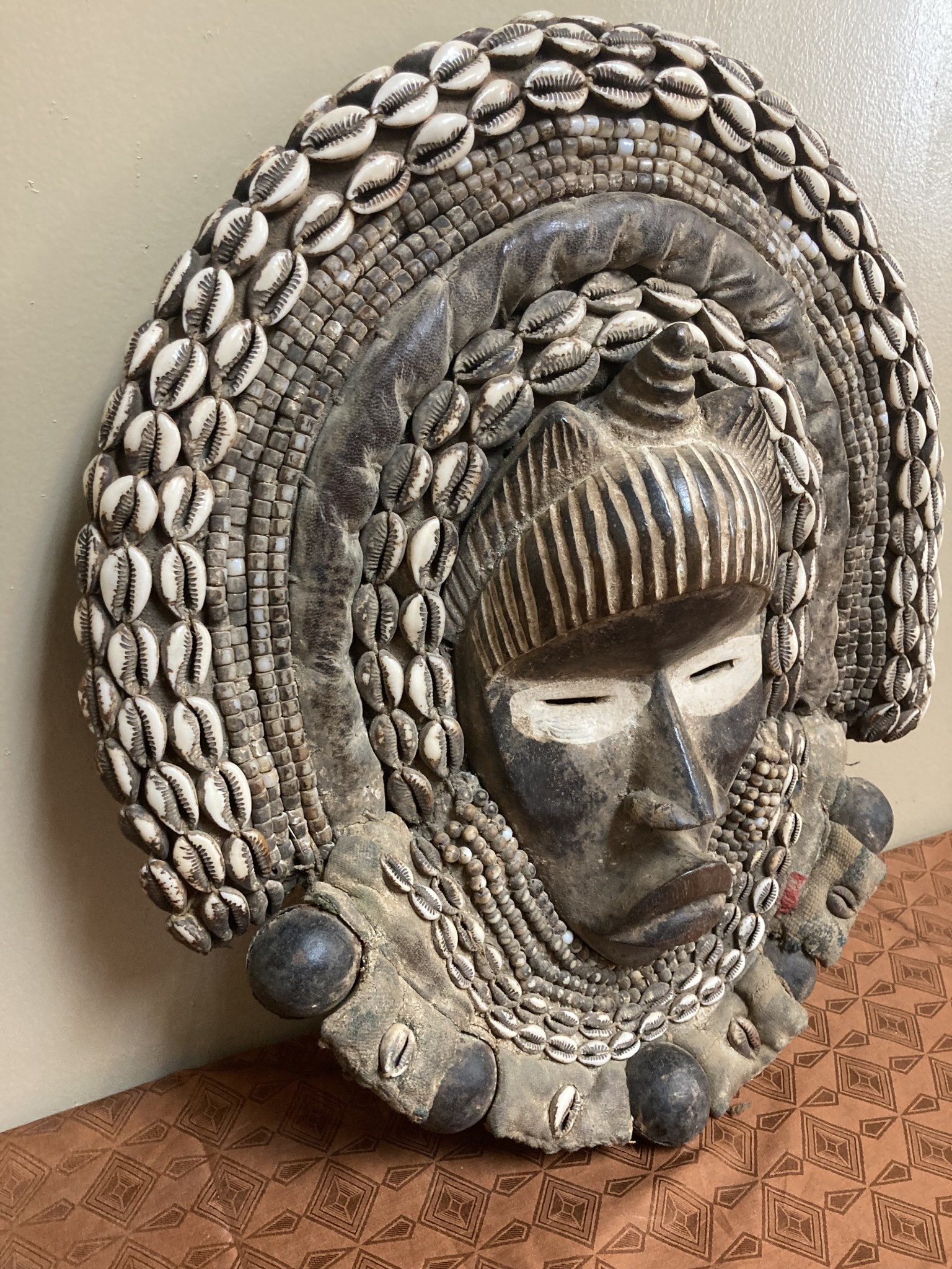 Dan (Yacuba) "Go Ge" mask: The job of this mask is to announce the death of the chief. The dan are found in SW ivory coast and next door in Liberia. Wood, cowrie shells, fabric, and kaolin (white colo