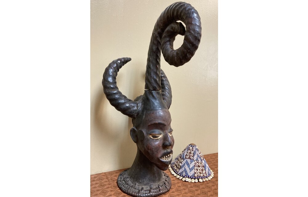 Ekoi (Ejagham): Ekoi wooden masks are covered with animal skin. These figures usually refer to cultural or war heroes. This piece was worn on the top of a woman's head. 20 1/4" tall x 11 1/4" W. Niger