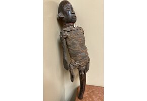 Makonde figure with handle. The Makonde live in East Africa in Mozambique, Tanzania with a small group in Kenya. This figure is used by entertainers and storytellers. Wood with cotton fabric and a cow