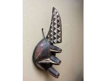 Ogoni Yam Festival Mask: At yam harvest time the Ogoni celebrate with a festival at which this mask with it’s 3 yams and crest representing the machete that cuts the vines. IT’s 17” tall and made of w