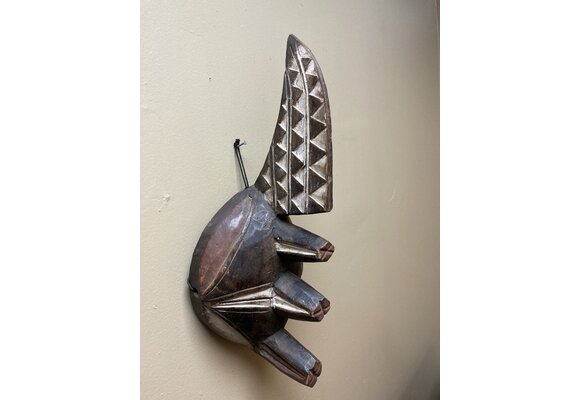 Ogoni Yam Festival Mask: At yam harvest time the Ogoni celebrate with a festival at which this mask with it’s 3 yams and crest representing the machete that cuts the vines. IT’s 17” tall and made of w