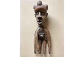 Bassa hand to serve as a power figure: The pouch in the hand’s palm contains magical substances. The piece is wooden and measures 17” long and 5 ⅞” wide. The Bassa reside in Liberia.