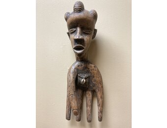 Bassa hand to serve as a power figure: The pouch in the hand’s palm contains magical substances. The piece is wooden and measures 17” long and 5 ⅞” wide. The Bassa reside in Liberia.