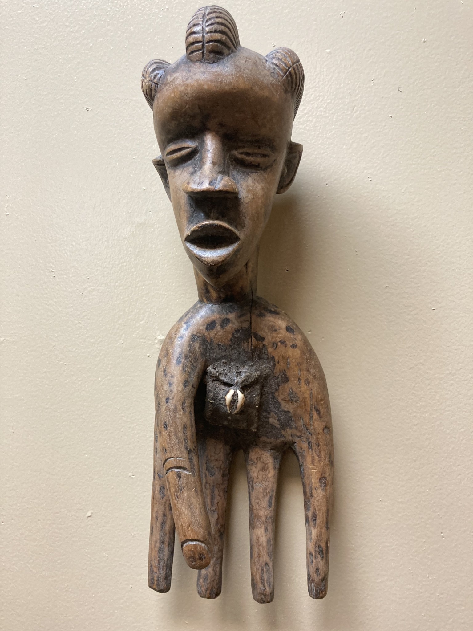 Bassa hand to serve as a power figure: The pouch in the hand’s palm contains magical substances. The piece is wooden and measures 17” long and 5 ⅞” wide. The Bassa reside in Liberia.