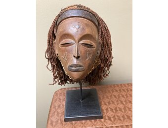 “Mwana Pwo” mask of the Chokwe (Tchokwe or Bajokwer) of Angola. Pwo is their word for woman. It represents a young woman who has been fully trained and is ready for marriage. Stand is included. Total
