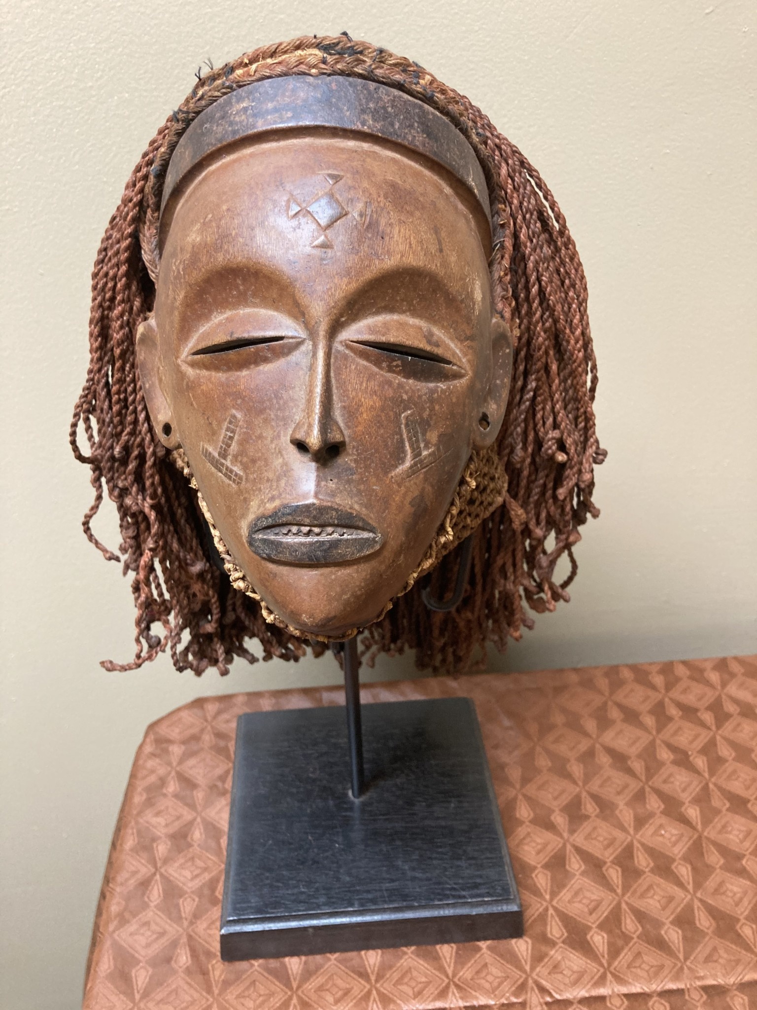 “Mwana Pwo” mask of the Chokwe (Tchokwe or Bajokwer) of Angola. Pwo is their word for woman. It represents a young woman who has been fully trained and is ready for marriage. Stand is included. Total
