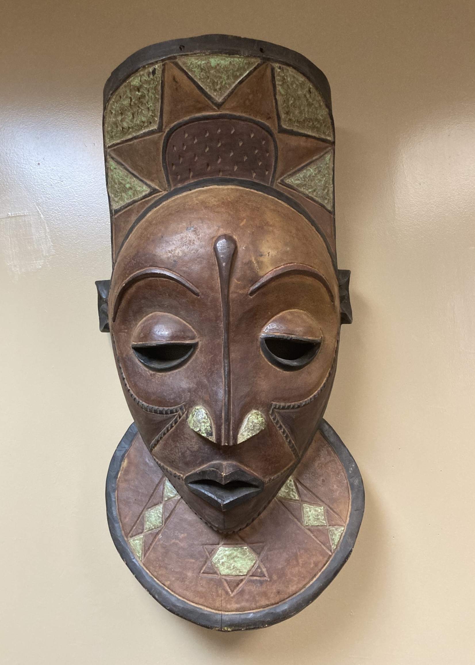 Pende Pende X-Large Mask: The Bapende are found in Dem Rep of Congo. This mask is 35 ½” tall and 16 ½” wide. Masks this size often decorated a meeting house. Wooden