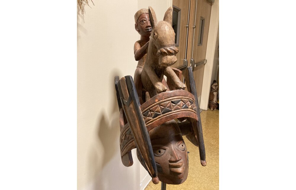 Yoruba "Gelede" mask. The Yoruba created this celebration in the 20th century. It celebrates older women, known to have much power, in a month-long event. Nigeria; wood 57 3/4" h on stand, 17 1/4" d x