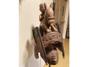 Yoruba "Gelede" mask. The Yoruba created this celebration in the 20th century. It celebrates older women, known to have much power, in a month-long event. Nigeria; wood 57 3/4" h on stand, 17 1/4" d x