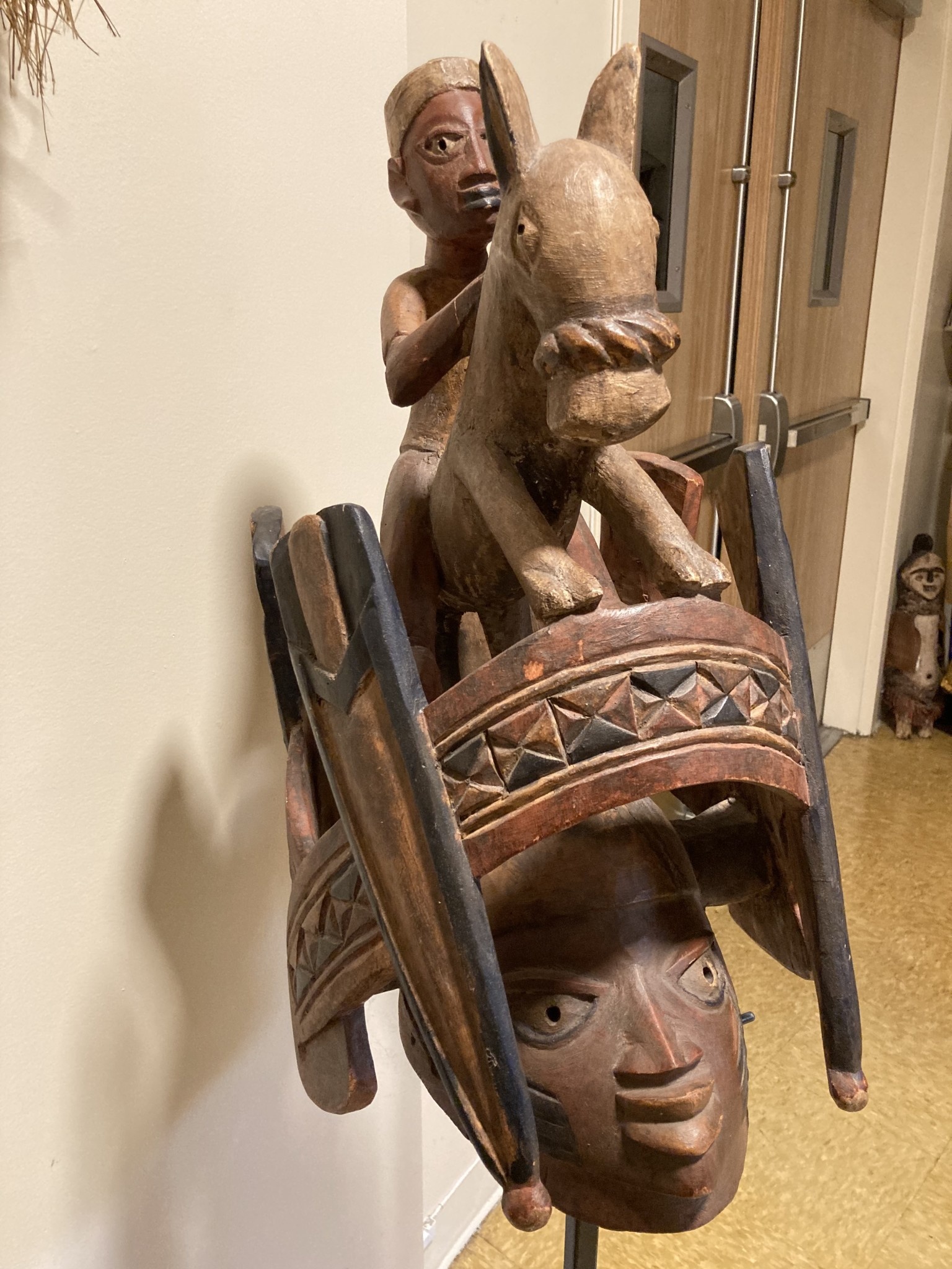 Yoruba "Gelede" mask. The Yoruba created this celebration in the 20th century. It celebrates older women, known to have much power, in a month-long event. Nigeria; wood 57 3/4" h on stand, 17 1/4" d x