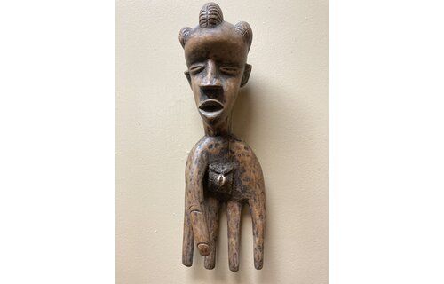 Bassa hand to serve as a power figure: The pouch in the hand’s palm contains magical substances. The piece is wooden and measures 17” long and 5 ⅞” wide. The Bassa reside in Liberia.