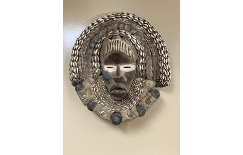 Dan (Yacuba) "Go Ge" mask: The job of this mask is to announce the death of the chief. The dan are found in SW ivory coast and next door in Liberia. Wood, cowrie shells, fabric, and kaolin (white colo