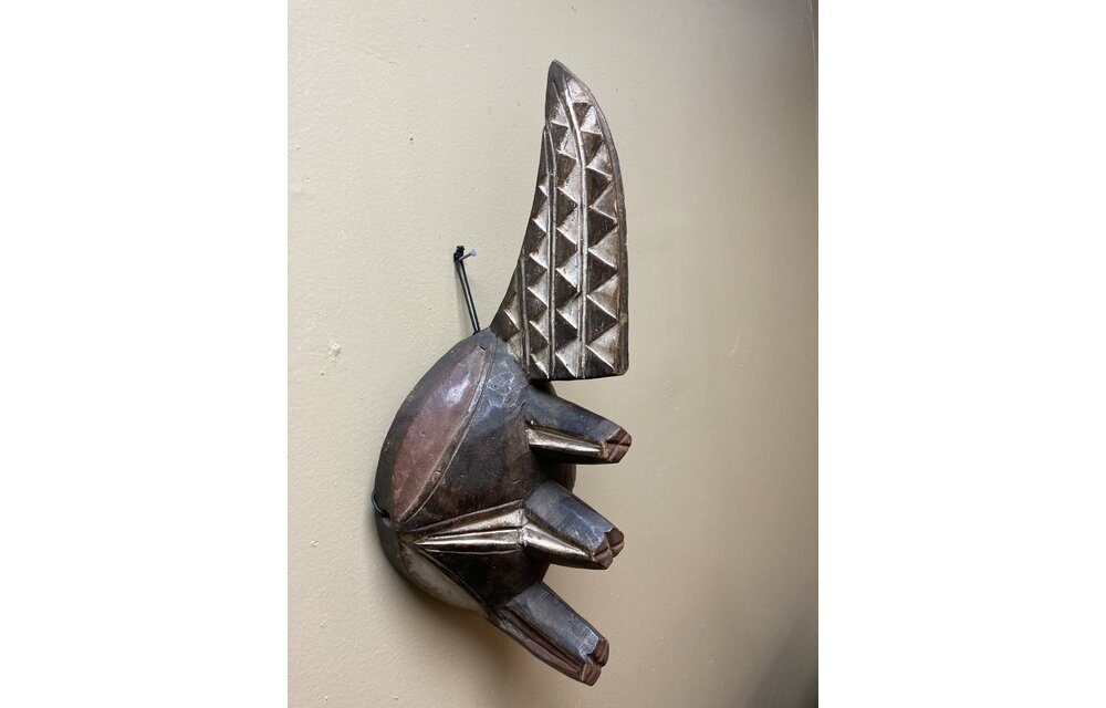 Ogoni Yam Festival Mask: At yam harvest time the Ogoni celebrate with a festival at which this mask with it’s 3 yams and crest representing the machete that cuts the vines. IT’s 17” tall and made of w