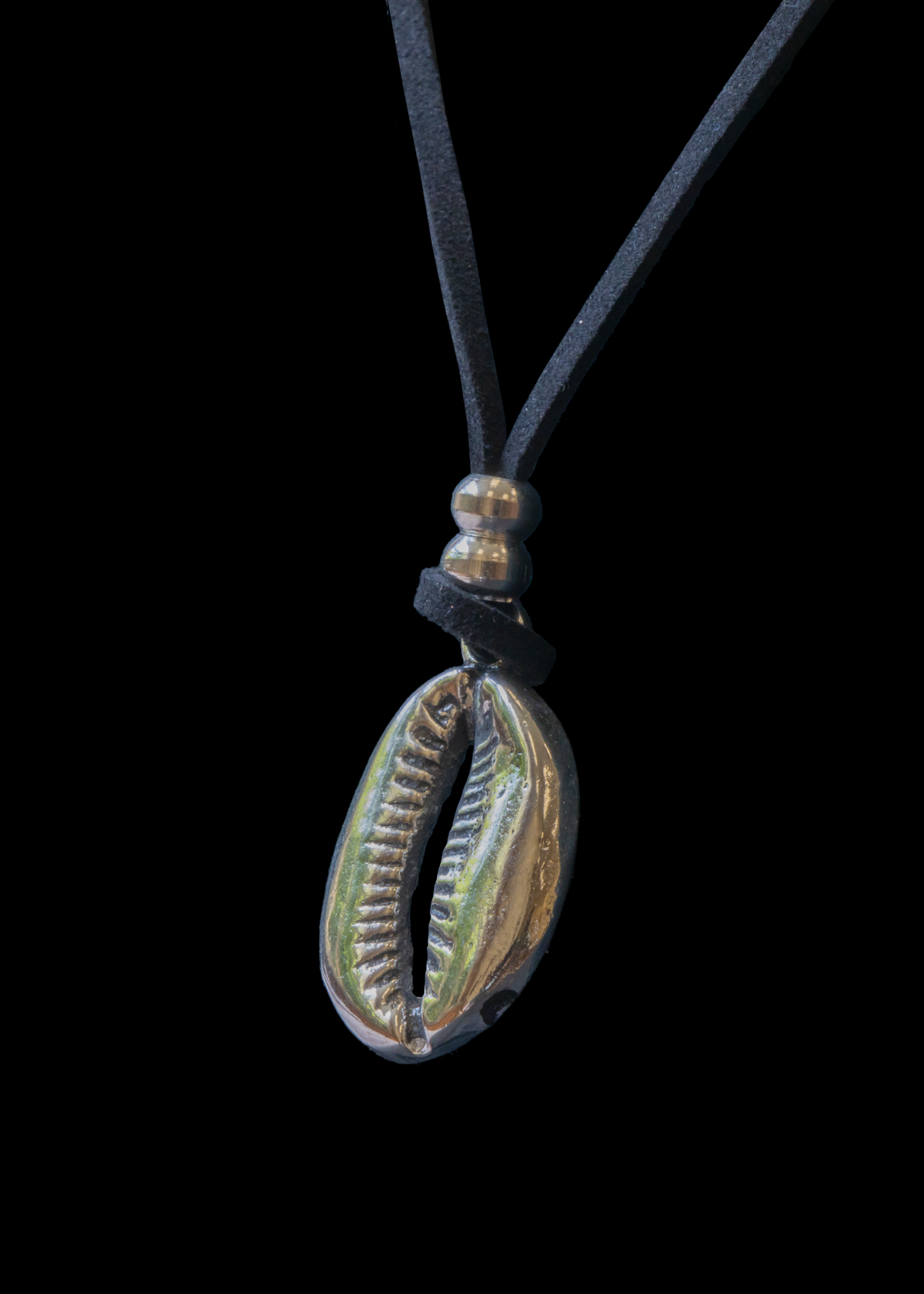 Silver cowrie pendant with leather cord.