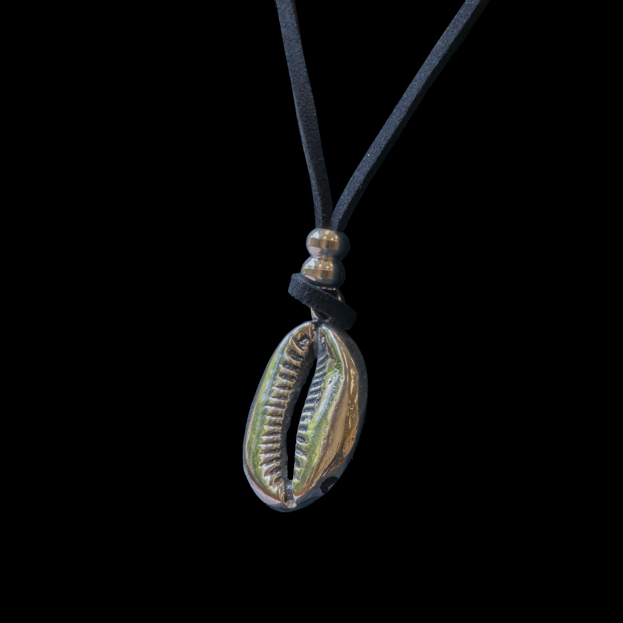 Silver cowrie pendant with leather cord.