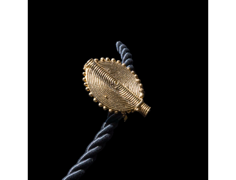 Corded necklace with large brass pendant and clip-on earrings.