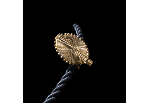 Corded necklace with large brass pendant and clip-on earrings.