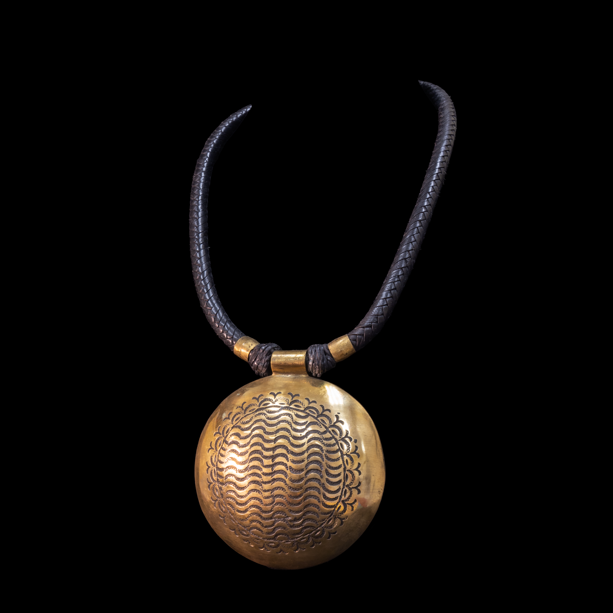 Attractive hand-made Tuareg necklace. Braided leather cord with large hand etched  brass pendant.