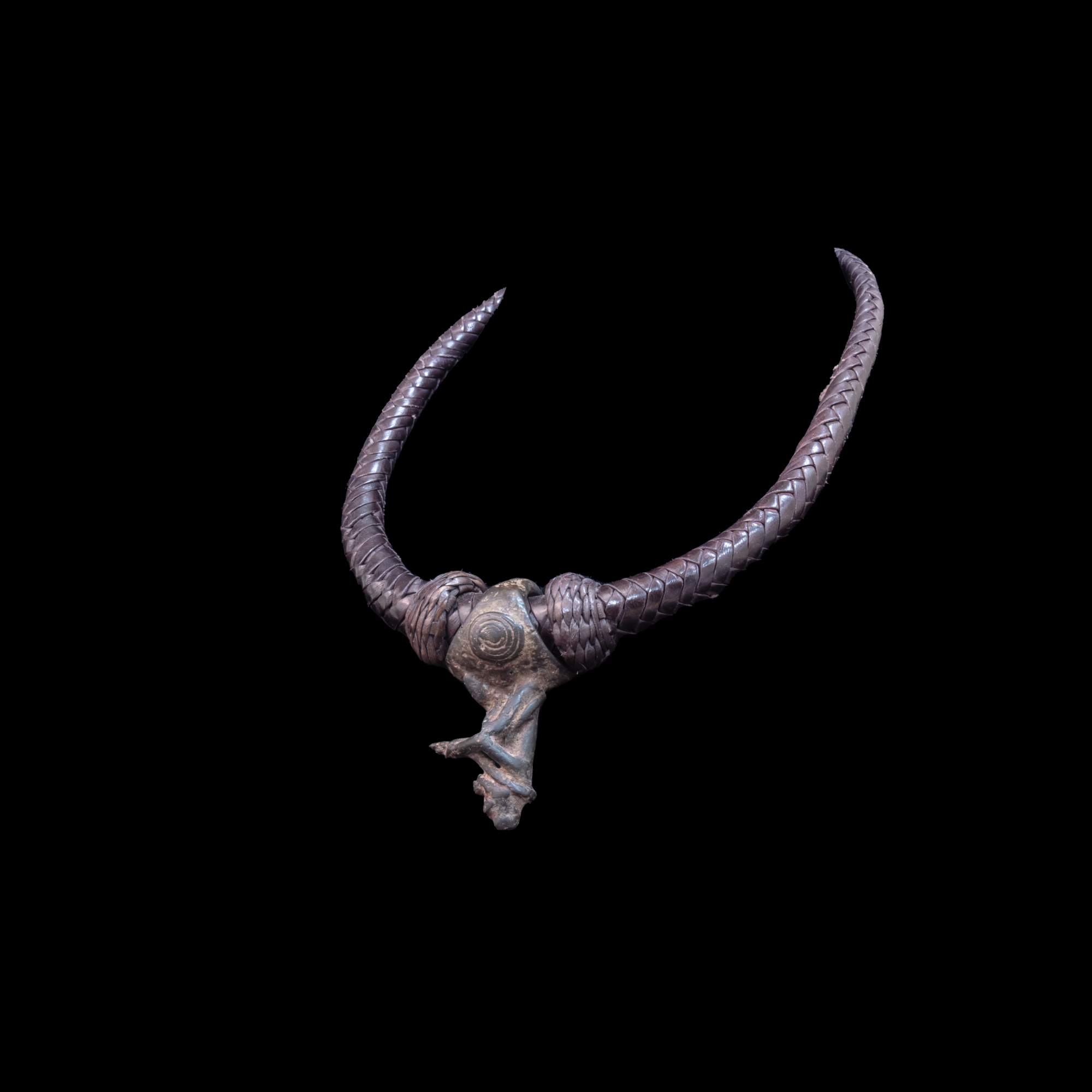 Braided leather necklace with small antique bronze pendant.