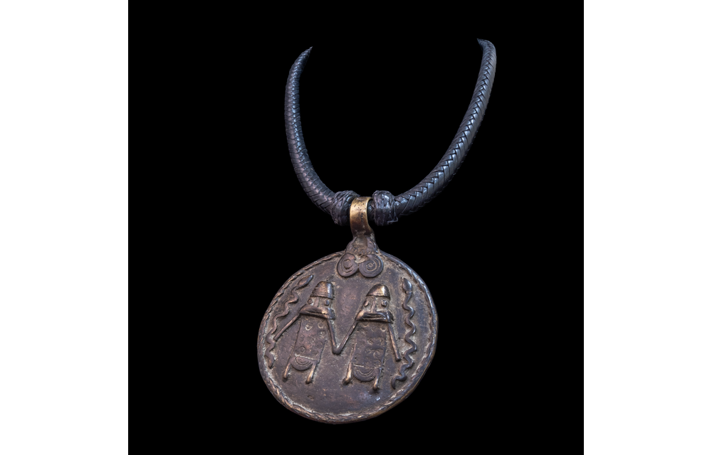 Braided leather necklace with antique bronze pendant.