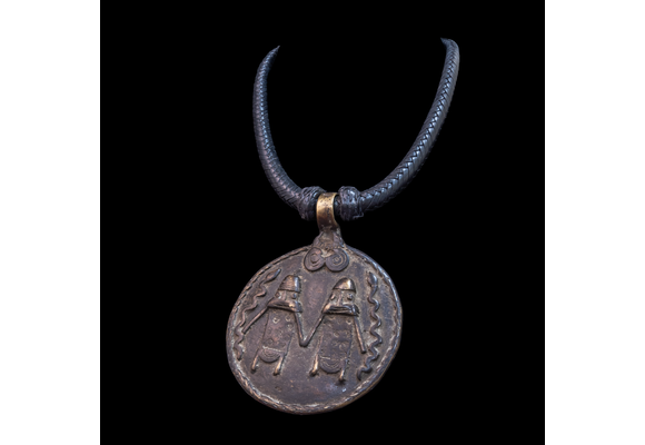 Braided leather necklace with antique bronze pendant.