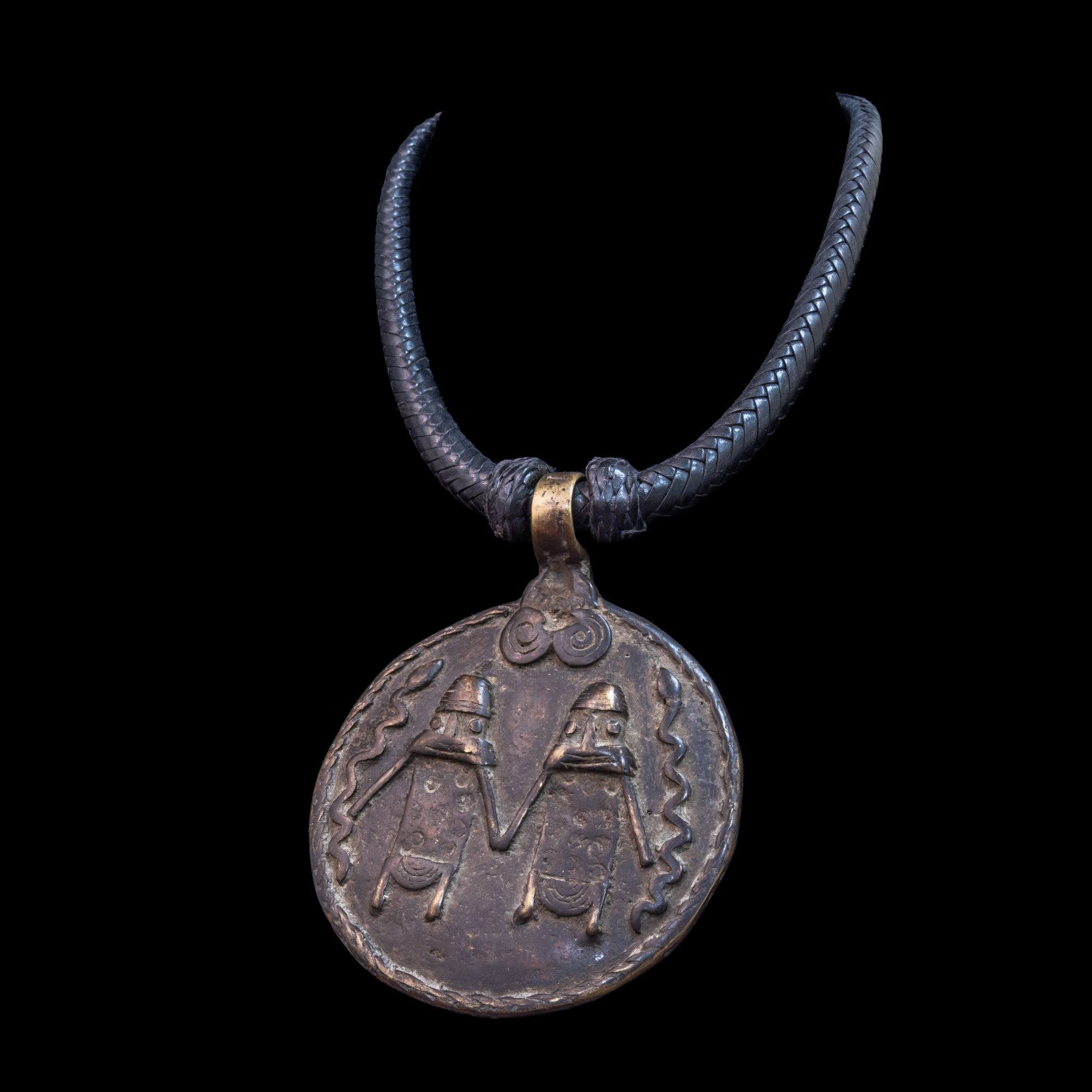 Braided leather necklace with antique bronze pendant.