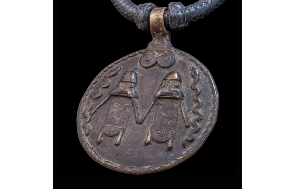 Braided leather necklace with antique bronze pendant.