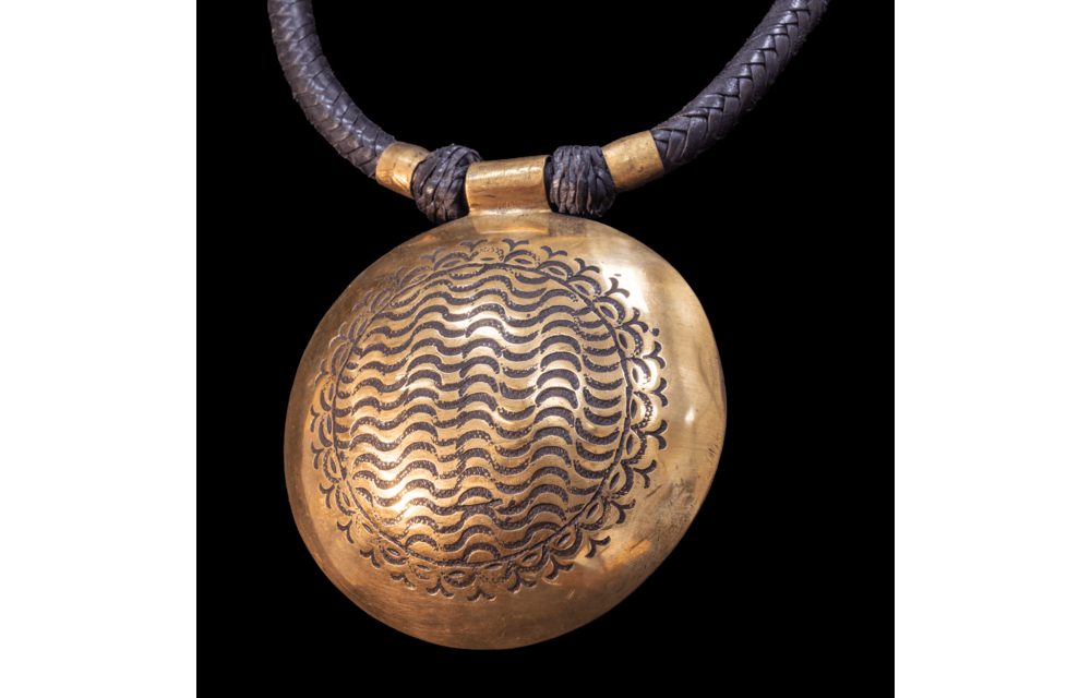 Attractive hand-made Tuareg necklace. Braided leather cord with large hand etched  brass pendant.