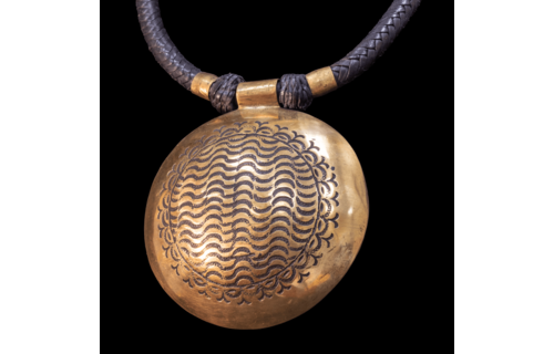 Attractive hand-made Tuareg necklace. Braided leather cord with large hand etched  brass pendant.