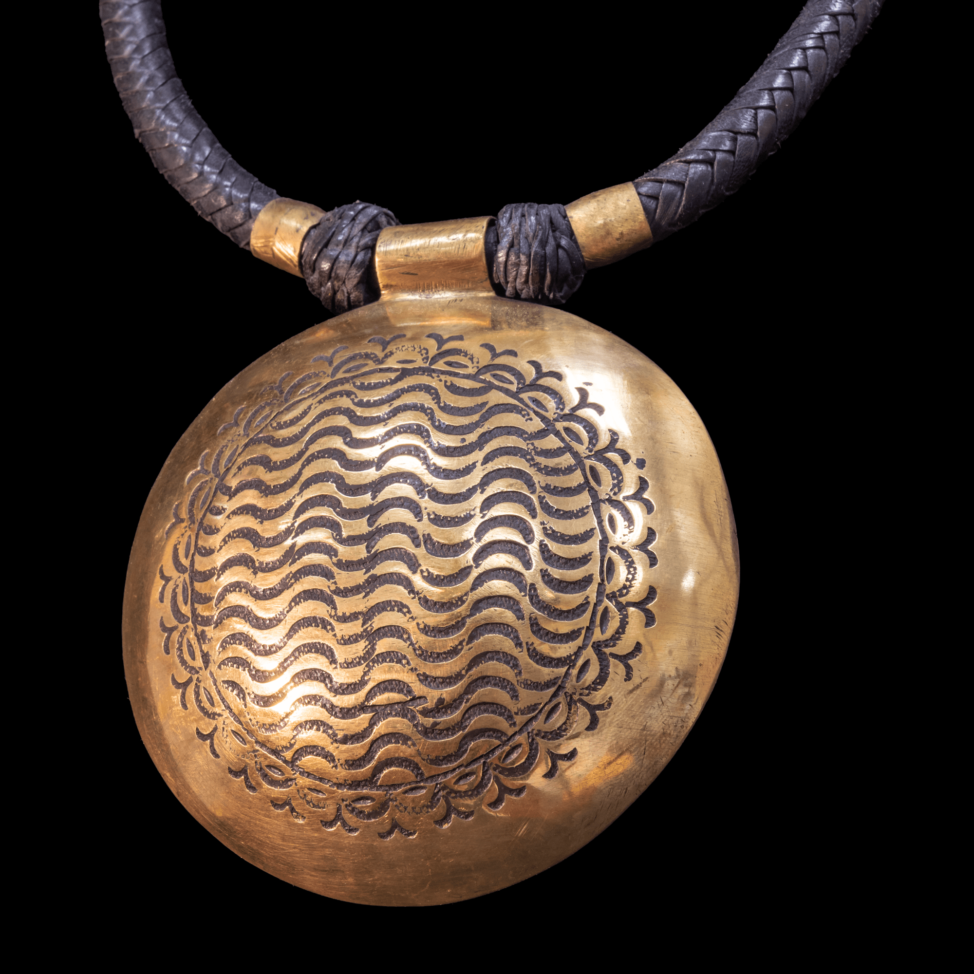 Attractive hand-made Tuareg necklace. Braided leather cord with large hand etched  brass pendant.