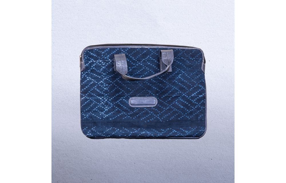 Cotton Indigo bag with leather trim and straps. Measures 14 x 9.5” Suitable for laptops.