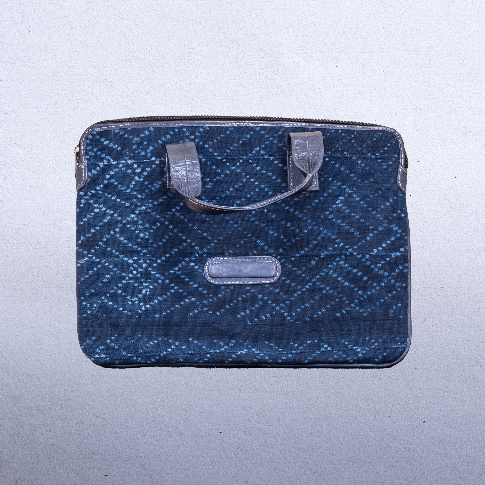 Cotton Indigo bag with leather trim and straps. Measures 14 x 9.5” Suitable for laptops.