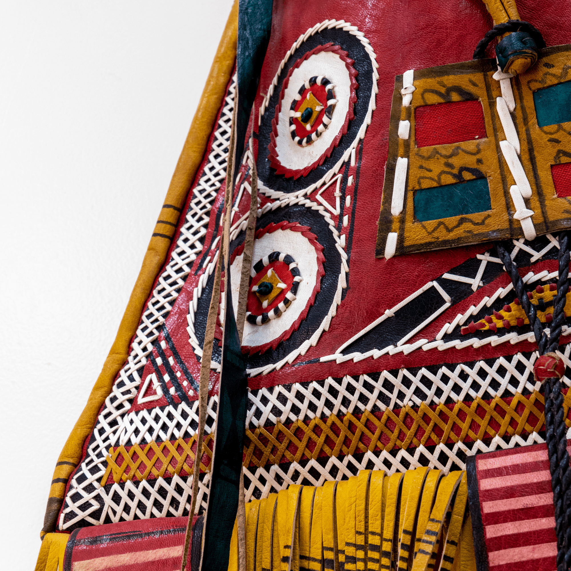 Modern take on traditional Tuareg camel leather bag. Ornate and colorful hand-made  leather bag with fringes.