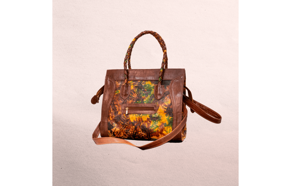 Leather body and trim. Short handles for carrying  and long shoulder straps. Inside and outside pockets! Top zipper. Measures 20.5” x 12.