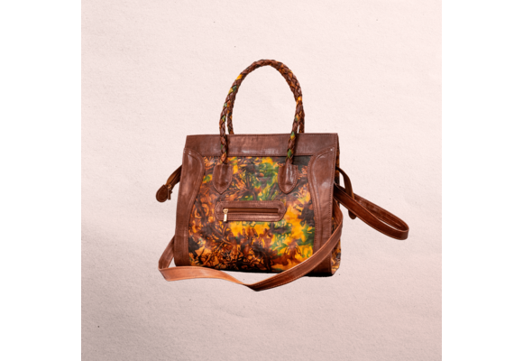 Leather body and trim. Short handles for carrying  and long shoulder straps. Inside and outside pockets! Top zipper. Measures 20.5” x 12.