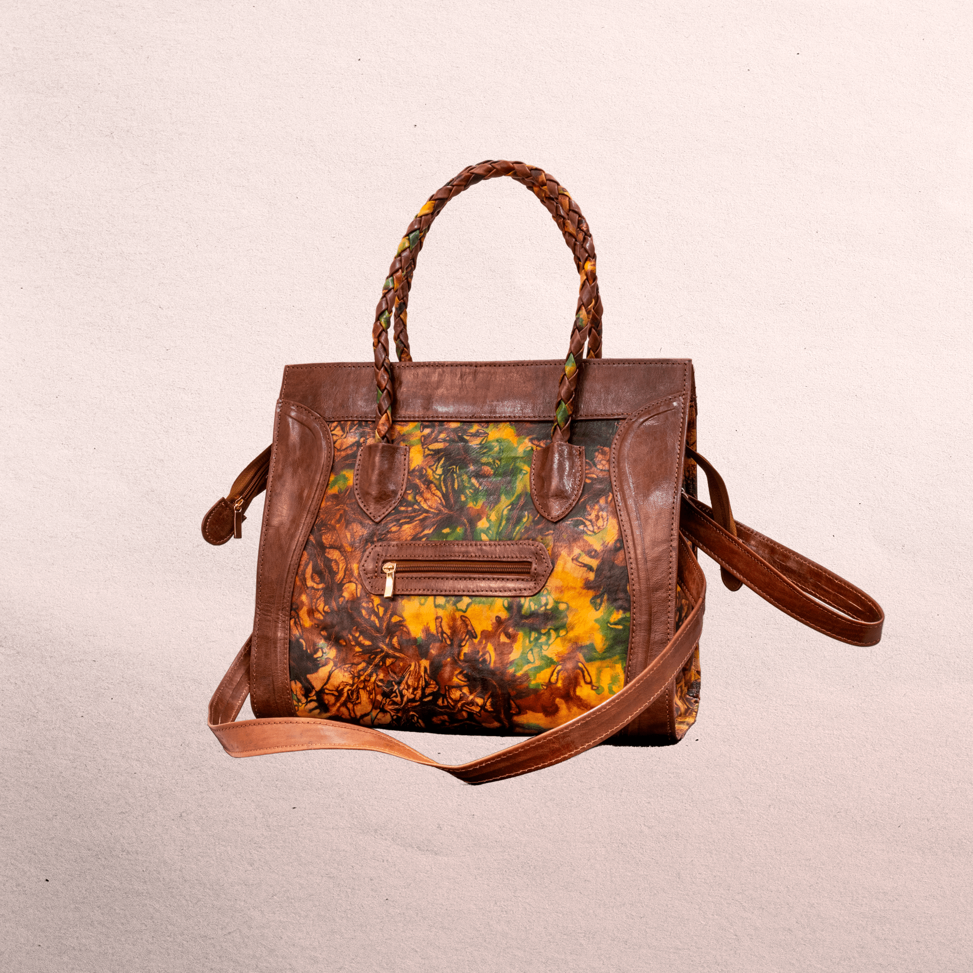 Leather body and trim. Short handles for carrying  and long shoulder straps. Inside and outside pockets! Top zipper. Measures 20.5” x 12.